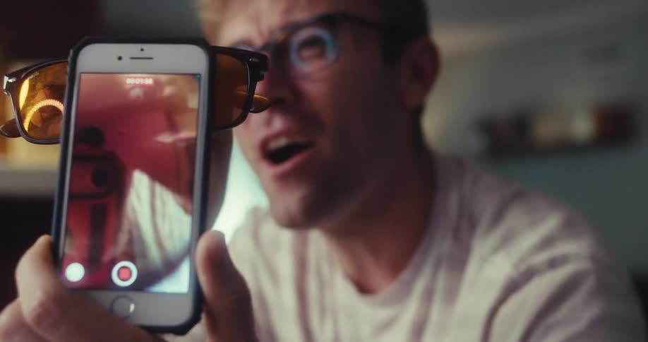 Man recording and presenting a brown sunglasses