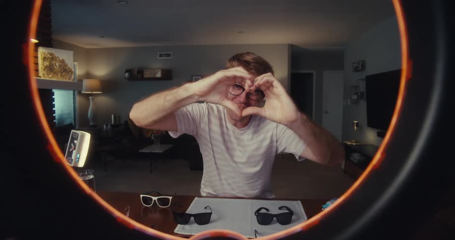 A footage of a man in front of a light strobe