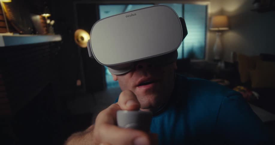 Man holding a controller and using virtual reality glasses