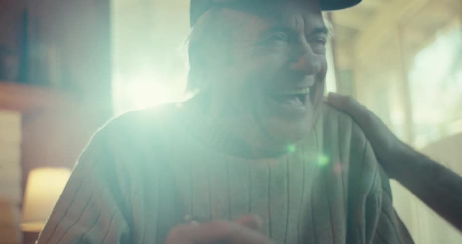 Very happy elderly man in cap holding a notebook