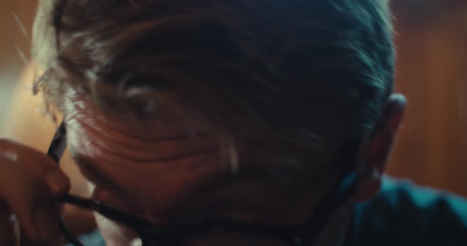 Man taking off his glasses while talking