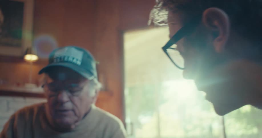 A man is talking with a friend and pointing at him