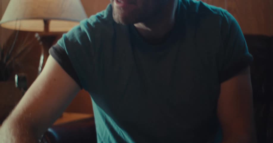 Man with glasses typing on a laptop