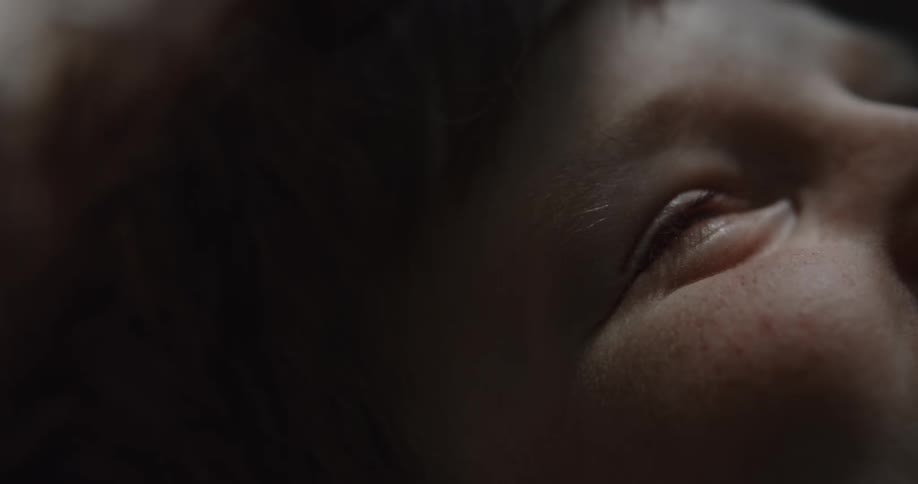 A boy is looking up as he smiles
