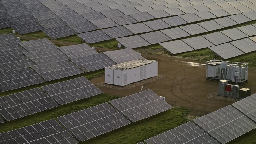 Battery grid storage unit in the middle of a large solar farm, aerial view