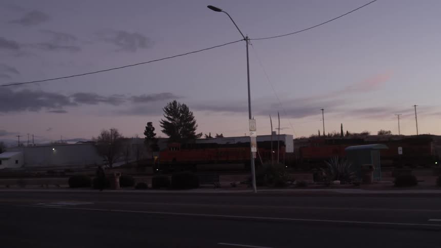 A train moves ahead on the tracks at dawn