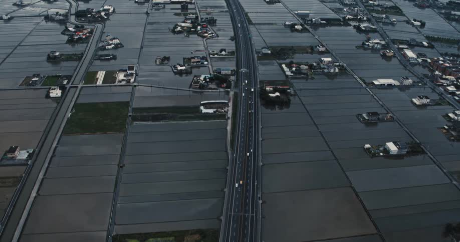 A road cuts through many fields