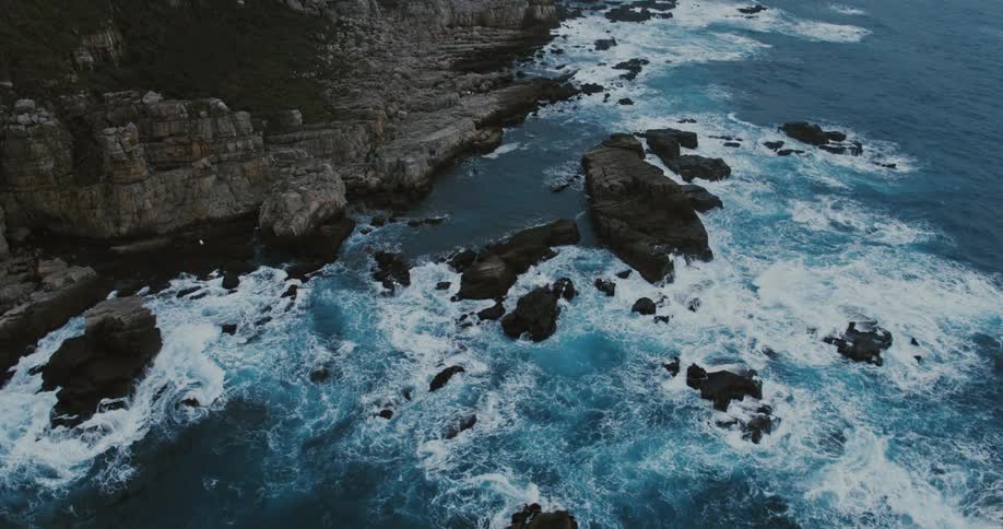 Waves crash among the rocks near the coast