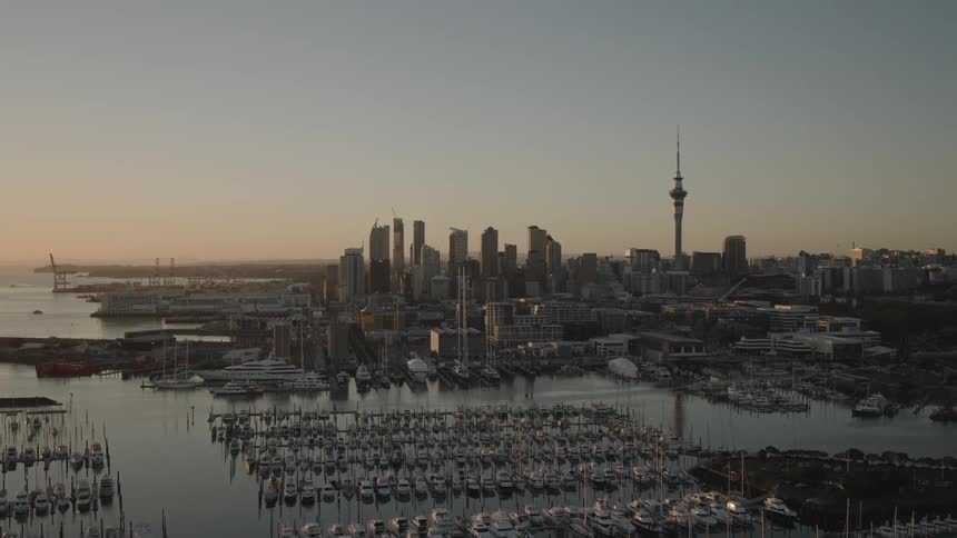 Space needle towers over skyscrapers in the background of a waterfront marina