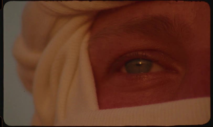Closeup of a persons eye partially covered by white fabric