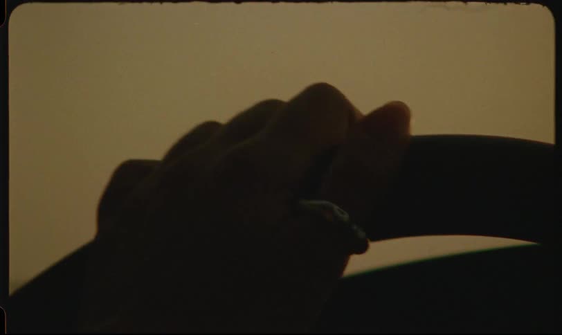 Woman wearing a ring drives a vehicle