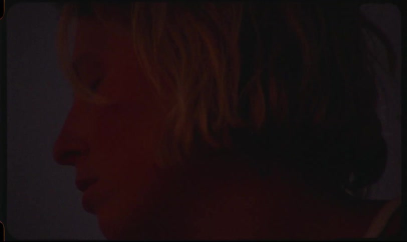 A blonde woman with her eyes closed lifting her head in distress