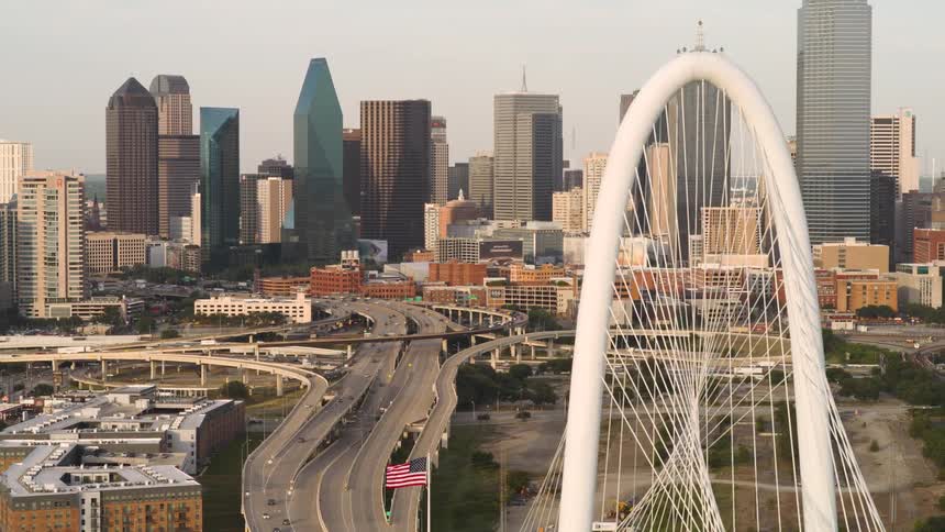 A large city with huge buildings and a big bridge filled with cars