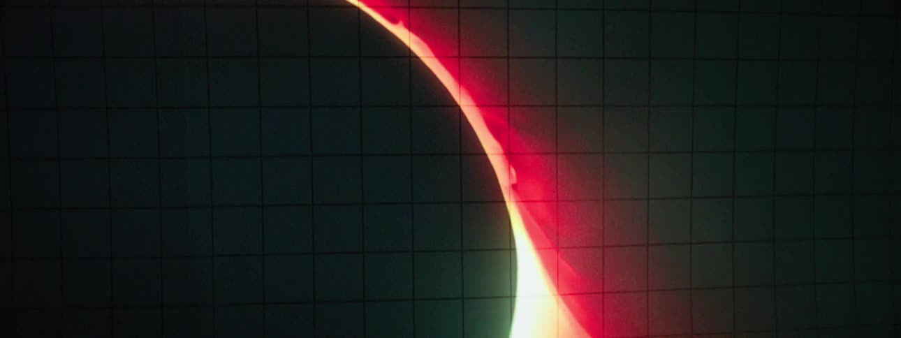 An image of a planet in the dark is projected on the wall