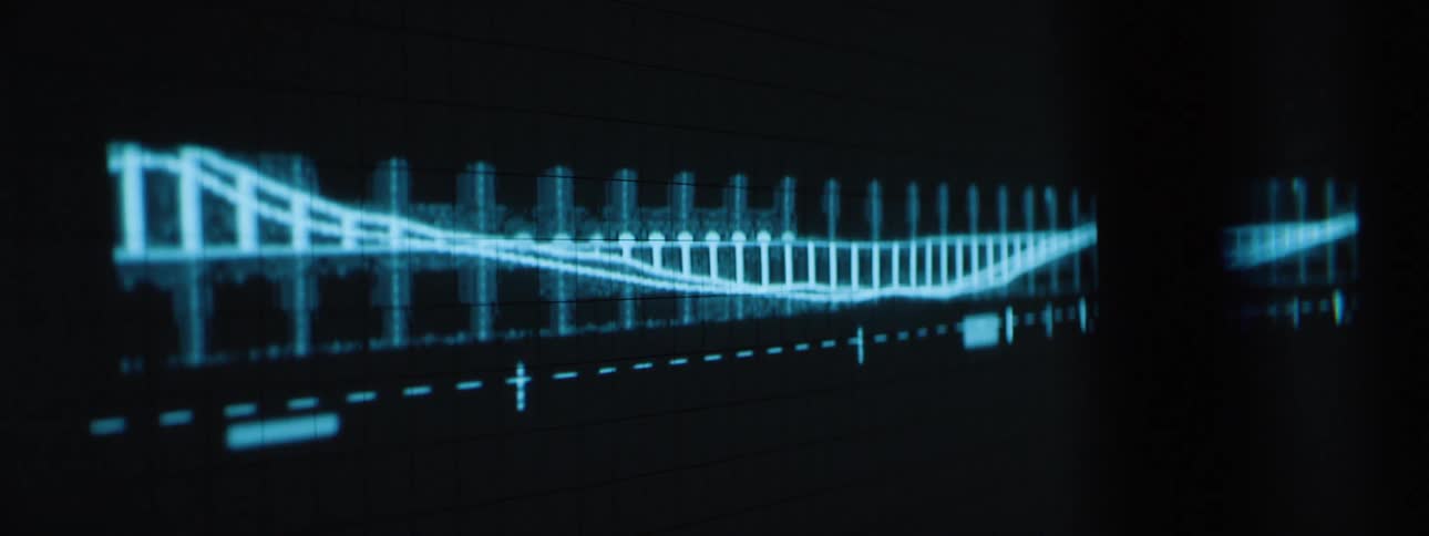 A line graph and numbers are projected on the wall