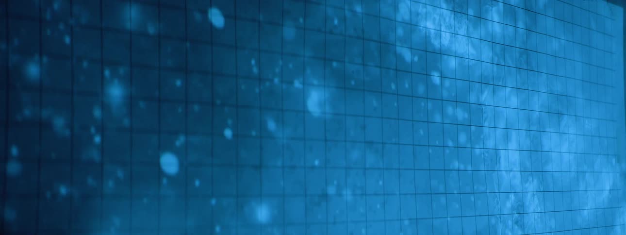 A large display showing a blue animation with a partial image of a womans face