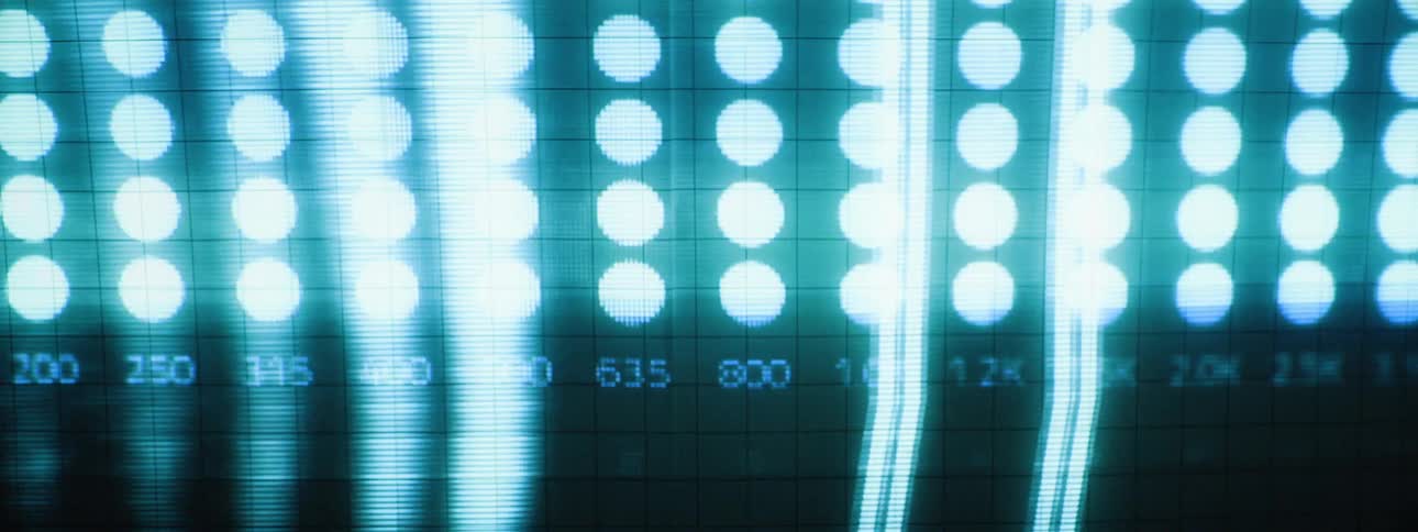 Light flashes on the computer screen partially obscuring columns of dots