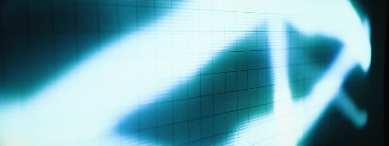 A blurred abstract pattern in shades of light blue and white dominates a screen with a visible grid