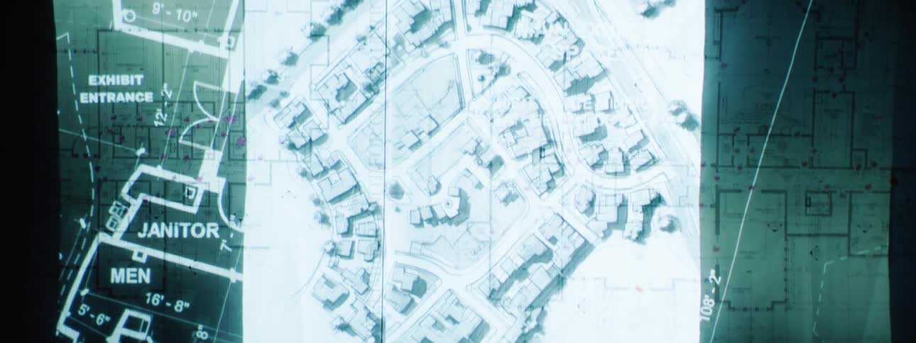 Overlapping architectural and urban planning blueprints detail building layouts dimensions and street grids creating a layered visualization of potential construction or development