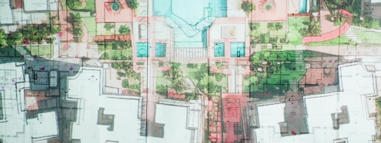A colorful architectural site plan shows a landscaped layout with buildings pools and walkways