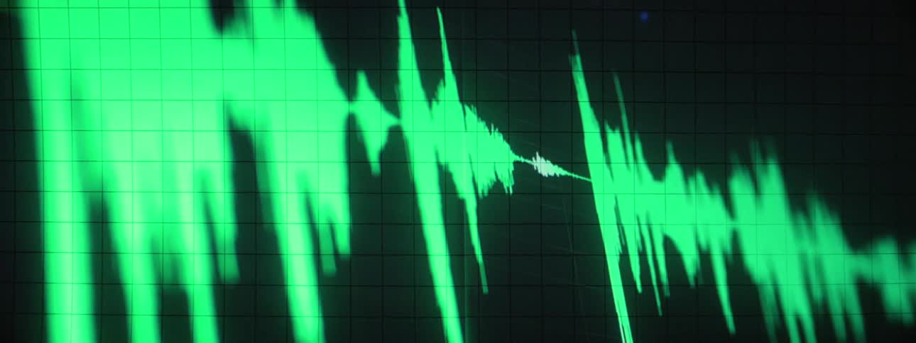 A frequency is displayed in green light on a monitor