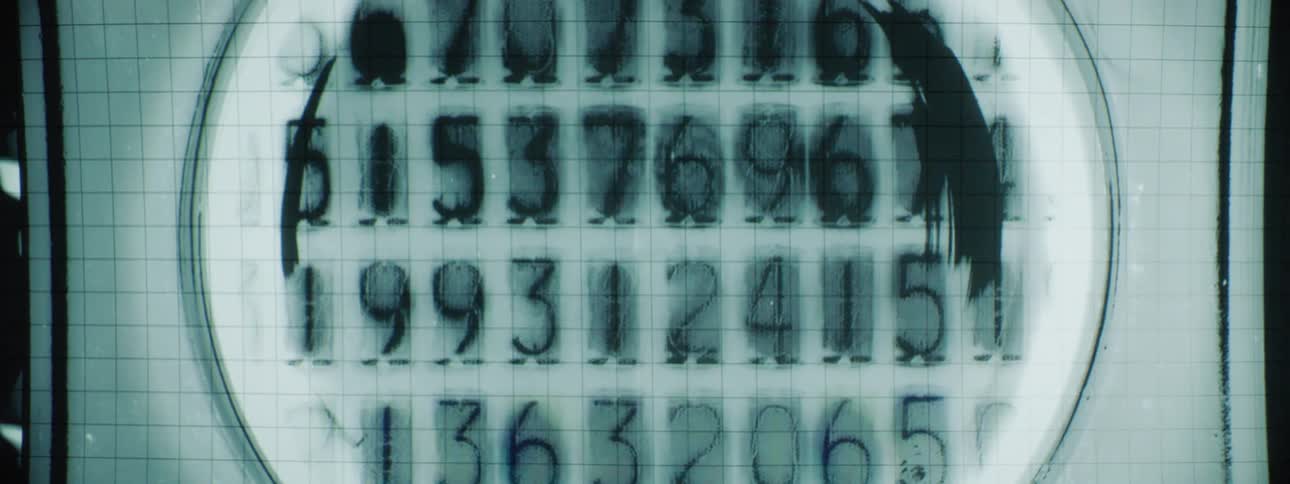 A round screen displaying many rapidly changing numbers