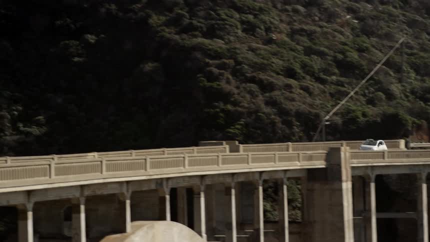 A car drives over a large drawbridge