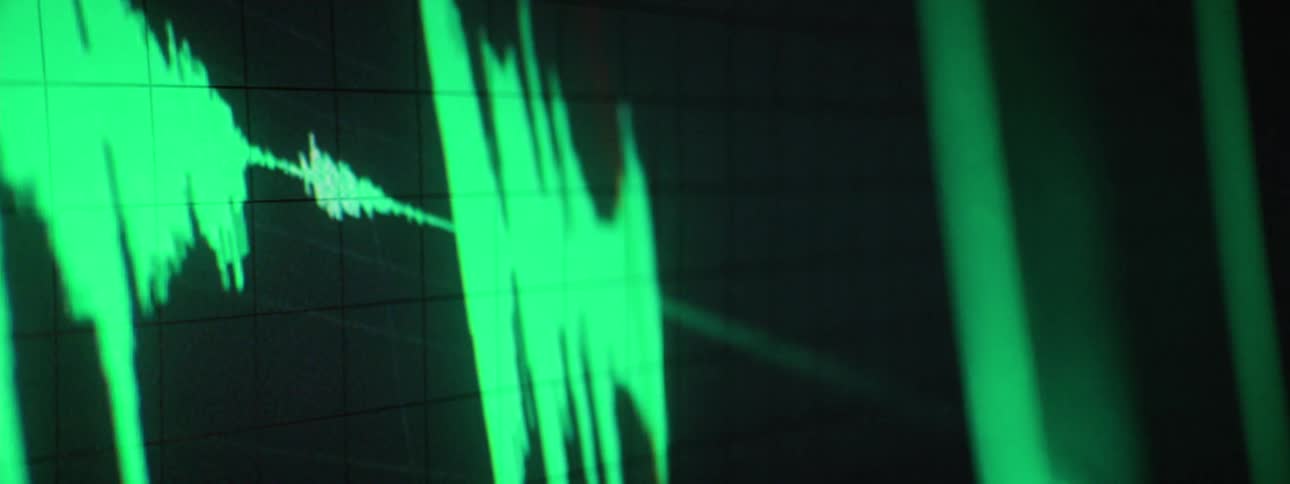 A monitor with a green graph on it