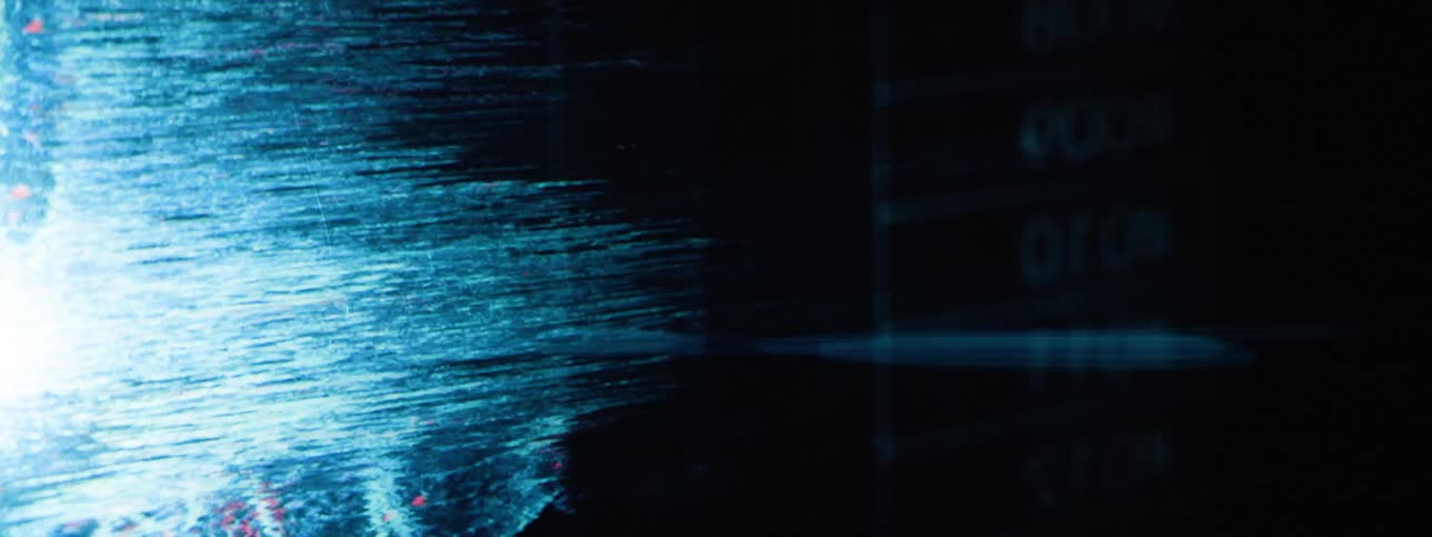 A glowing wireframe model of a human heart is displayed against a dark background with static effects