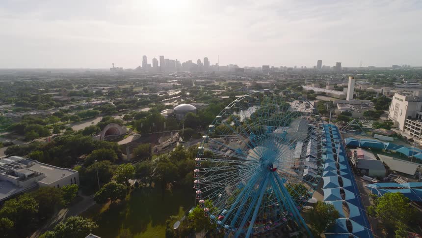 A large ferris wheel is by the carnival