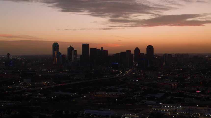Tall buildings fill the city at dusk