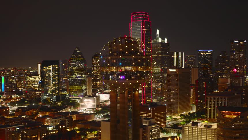 Spherical structure tops a downtown tower at night