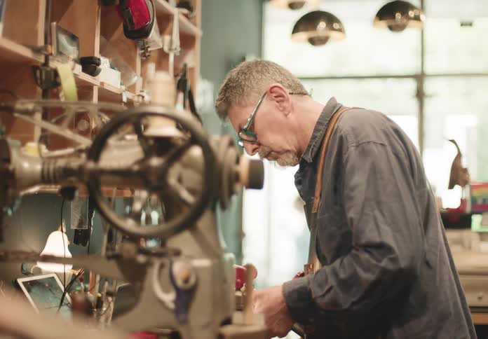 A man is woodworking in the shop