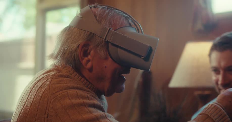 Two men talk while one is using a vr headset