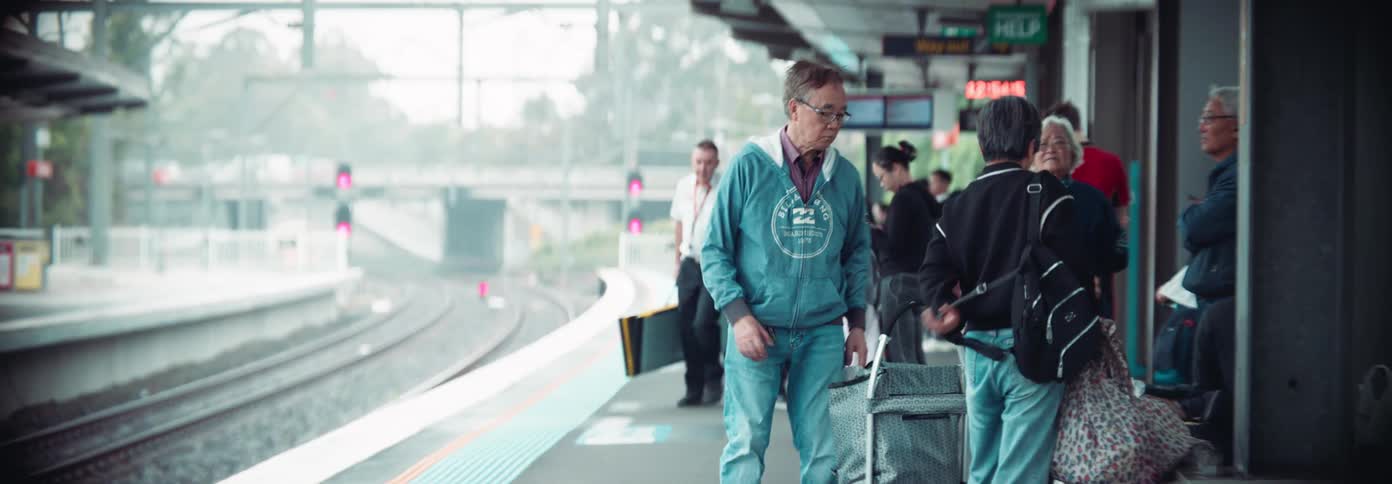 People are waiting with their luggage for the train