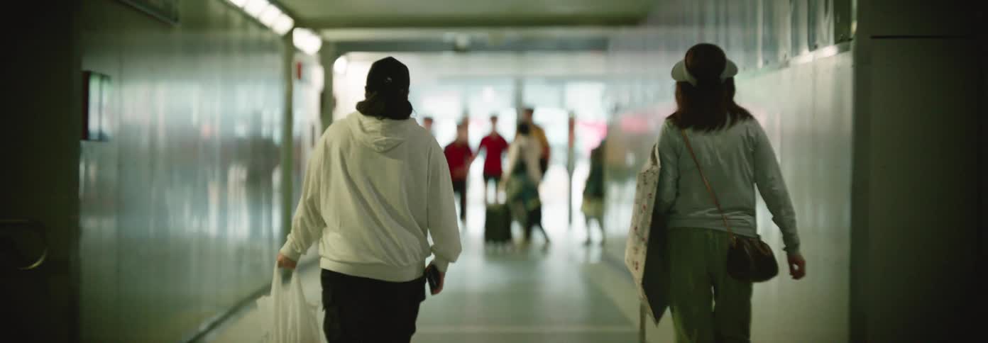 People walk down the hall in the train station