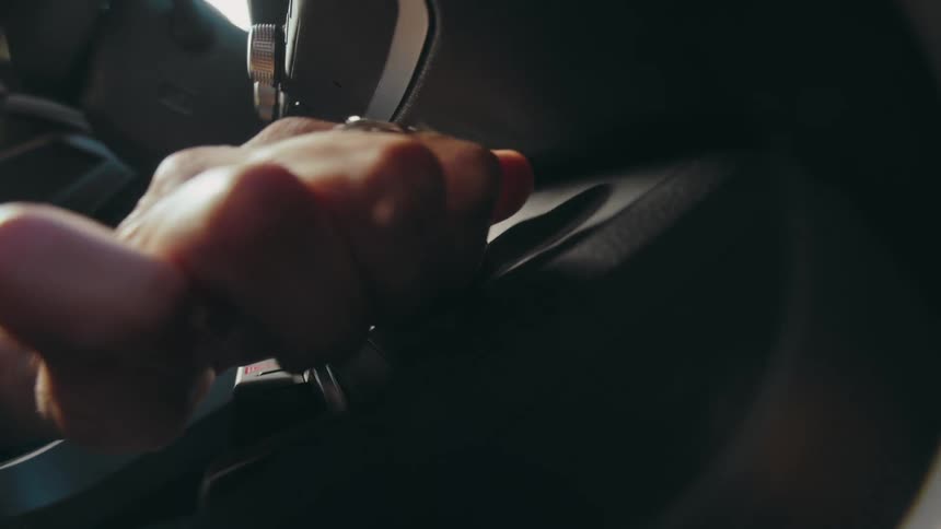Close up of a hand turning a knob on a car console