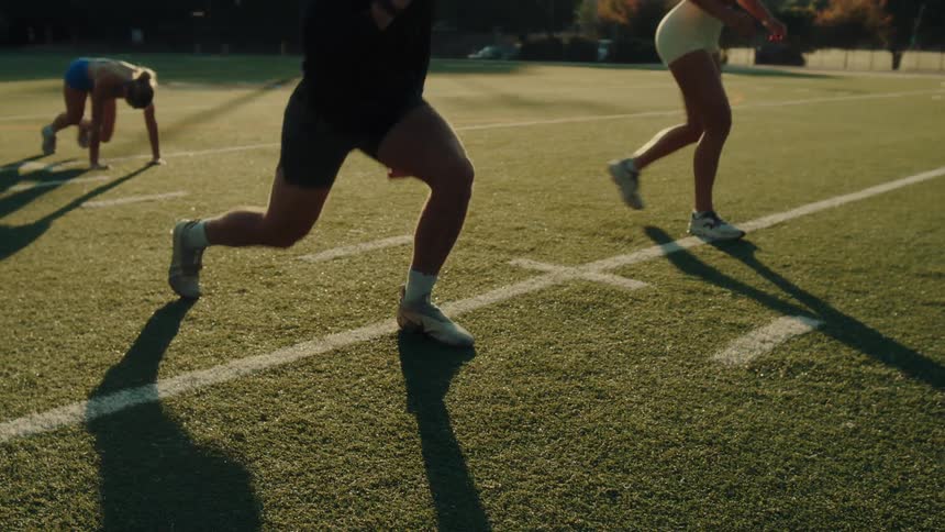 People exercise on a football field on a sunny autumn day