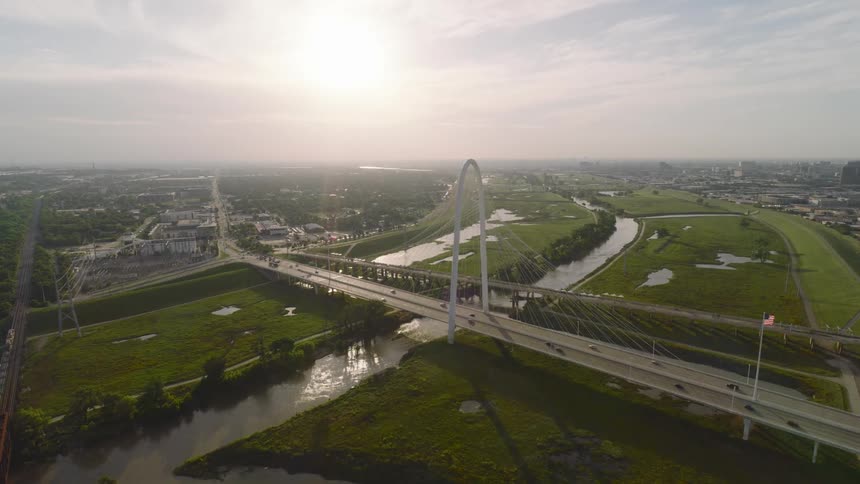 Aerial view of a cablestayed bridge over a river at sunrise
