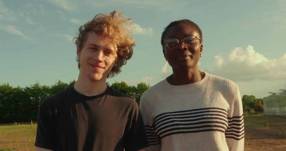 Two friends pose together and look into the camera for a picture