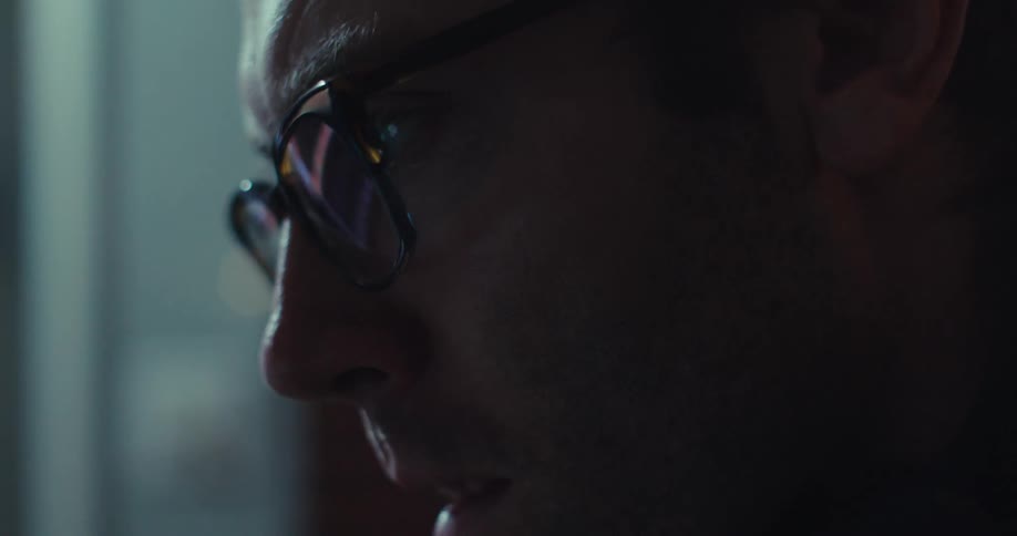 A man is concentrating on a computer screen