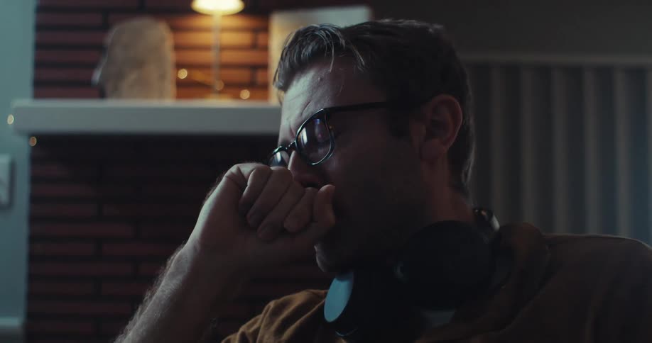 A man gets upset after looking at his cell phone