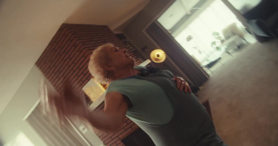 A woman is dancing in the living room