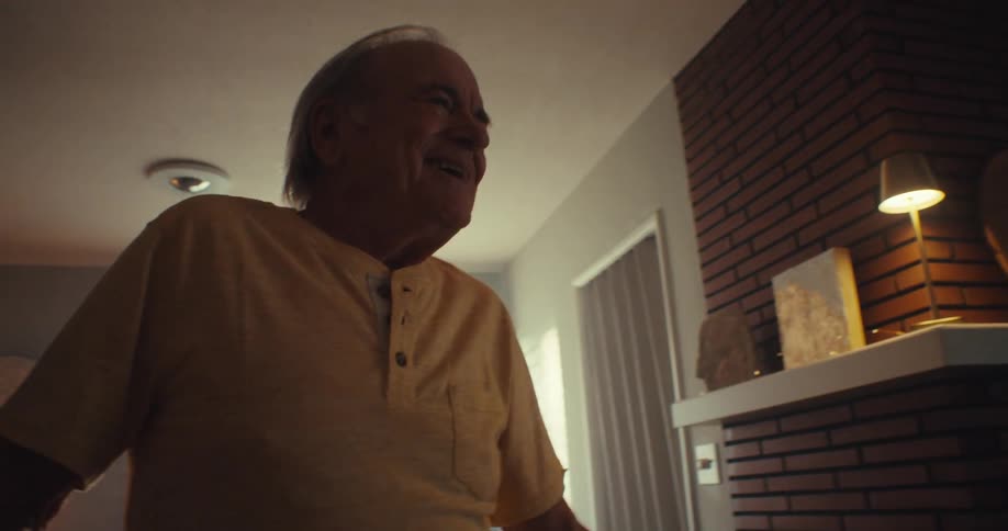 Two people dance together at home