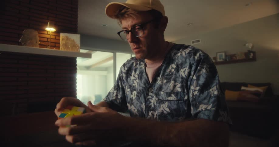 A man is trying to solve the rubiks cube