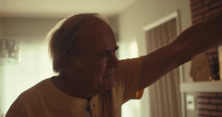 A couple are smiling and dancing at home