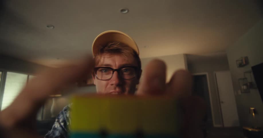 A man is having fun solving a rubiks cube