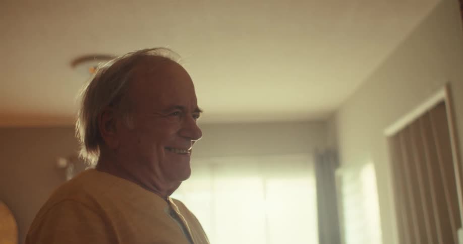 An elderly couple joyfully dances hand in hand