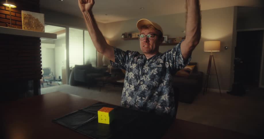 A man is happy after solving the rubiks cube