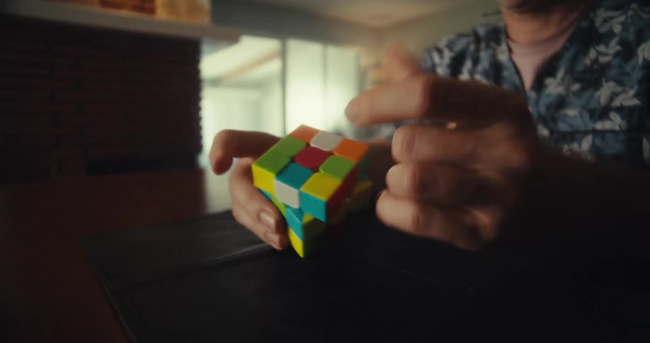 A man is trying to solve a rubiks cube